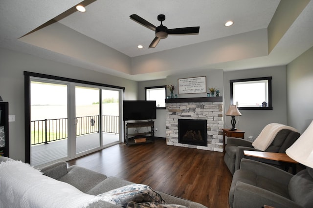 1800 20th Avenue Cir NE, Kasson, MN 55944 - living area featuring wood finished floors, a ceiling fan, a stone fireplace, a raised ceiling, and recessed lighting