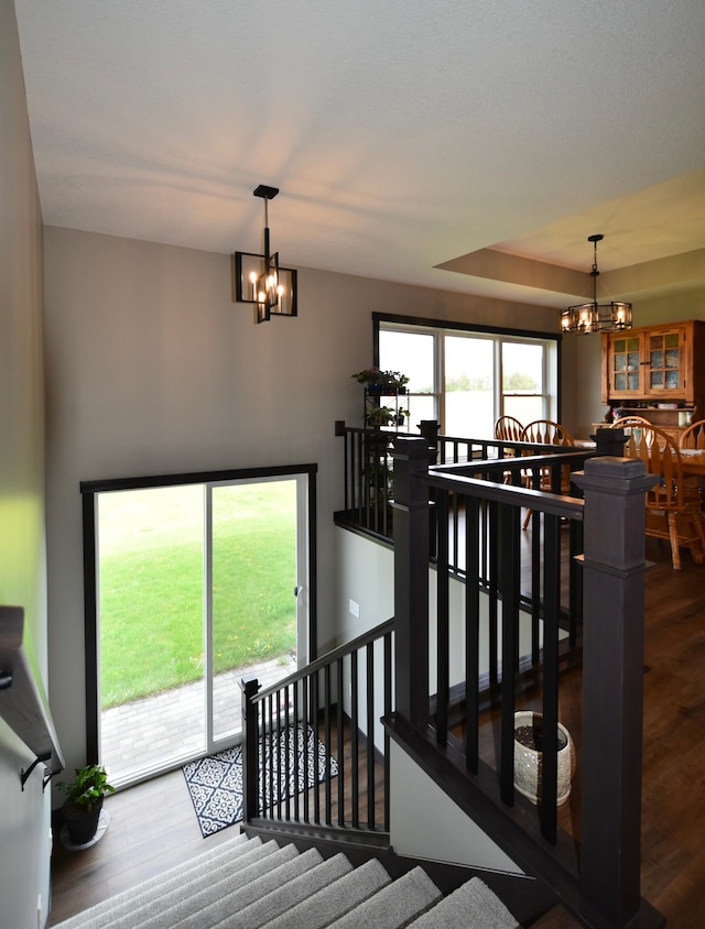 1800 20th Avenue Cir NE, Kasson, MN 55944 - stairway with a chandelier and wood finished floors