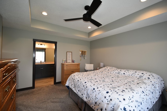 1800 20th Avenue Cir NE, Kasson, MN 55944 - bedroom featuring dark colored carpet, a raised ceiling, recessed lighting, baseboards, and connected bathroom