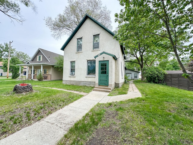 226 3rd Ave NE, Saint Cloud, MN 56304 - view of front facade with stucco siding, a front yard, and a porch