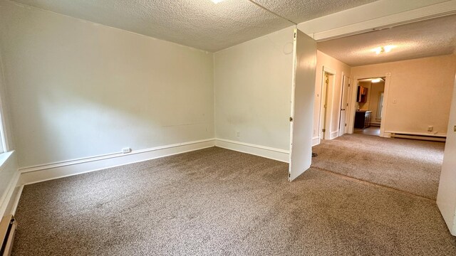 226 3rd Ave NE, Saint Cloud, MN 56304 - empty room featuring a baseboard radiator, a textured ceiling, dark colored carpet, and baseboards