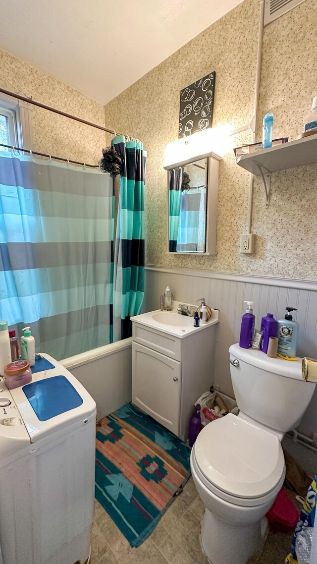 226 3rd Ave NE, Saint Cloud, MN 56304 - bathroom featuring toilet, shower / tub combo, wainscoting, and vanity