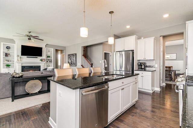 4740 Ashton Curv, Woodbury, MN 55129 - kitchen featuring stainless steel appliances, a sink, ceiling fan, open floor plan, and dark wood-type flooring