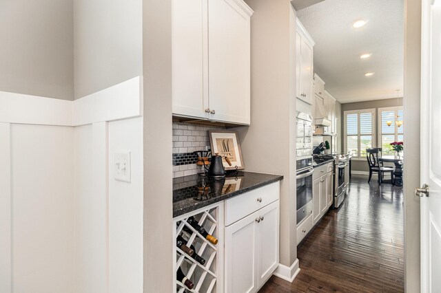 4740 Ashton Curv, Woodbury, MN 55129 - kitchen with appliances with stainless steel finishes, tasteful backsplash, dark wood-style flooring, recessed lighting, and white cabinets