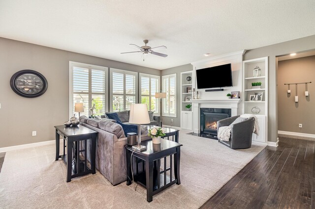 4740 Ashton Curv, Woodbury, MN 55129 - living area featuring ceiling fan, baseboards, a fireplace with flush hearth, wood finished floors, and built in shelves