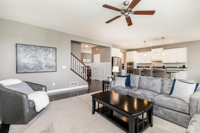 4740 Ashton Curv, Woodbury, MN 55129 - living area with ceiling fan, stairway, recessed lighting, baseboards, and light wood finished floors