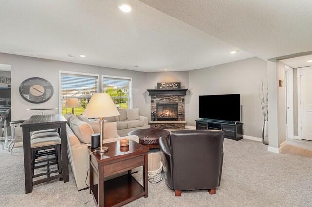 4740 Ashton Curv, Woodbury, MN 55129 - living room featuring light colored carpet, a stone fireplace, recessed lighting, baseboards, and a textured ceiling