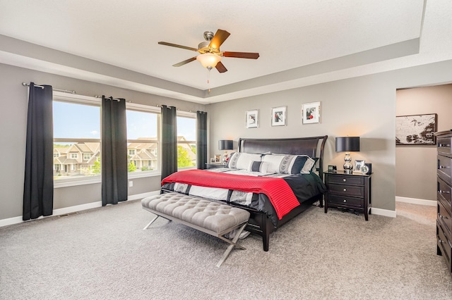 4740 Ashton Curv, Woodbury, MN 55129 - bedroom with light carpet, a tray ceiling, baseboards, and ceiling fan