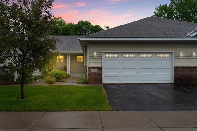 13403 96th Pl N, Maple Grove, MN 55369 - view of front of house with brick siding, a garage, driveway, and roof with shingles