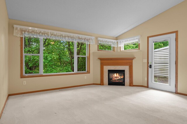 13403 96th Pl N, Maple Grove, MN 55369 - unfurnished living room featuring carpet flooring, baseboards, plenty of natural light, a fireplace, and lofted ceiling