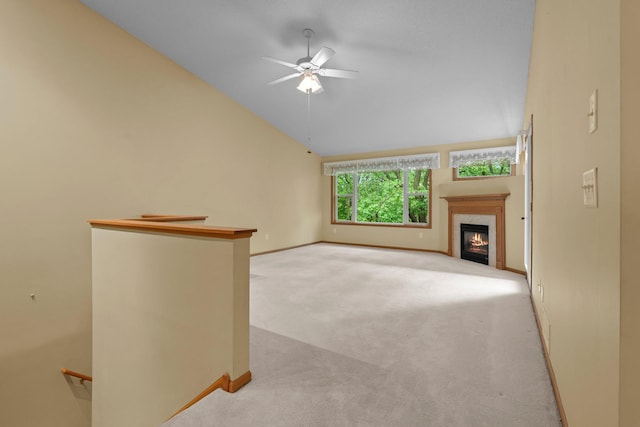 13403 96th Pl N, Maple Grove, MN 55369 - unfurnished living room featuring carpet flooring, lofted ceiling, a ceiling fan, a glass covered fireplace, and baseboards