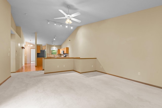 13403 96th Pl N, Maple Grove, MN 55369 - unfurnished living room with light colored carpet, ceiling fan, baseboards, track lighting, and high vaulted ceiling