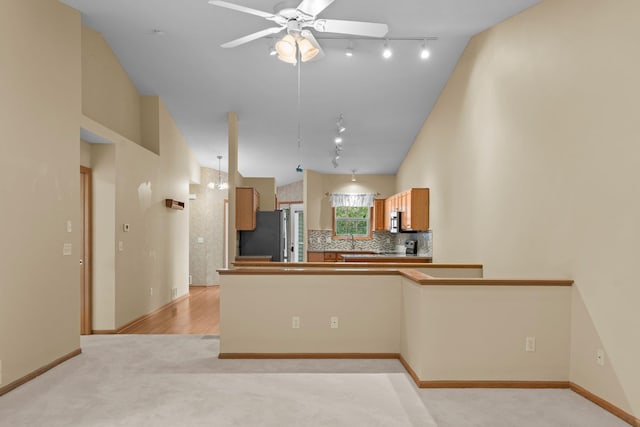 13403 96th Pl N, Maple Grove, MN 55369 - kitchen with rail lighting, freestanding refrigerator, a ceiling fan, lofted ceiling, and decorative backsplash