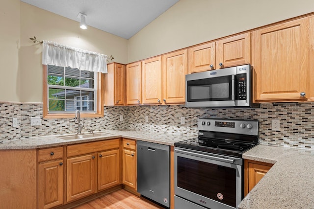 13403 96th Pl N, Maple Grove, MN 55369 - kitchen with appliances with stainless steel finishes, a sink, light stone countertops, and decorative backsplash