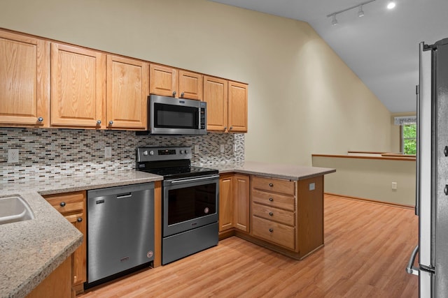 13403 96th Pl N, Maple Grove, MN 55369 - kitchen with stainless steel appliances, vaulted ceiling, a peninsula, decorative backsplash, and light wood-style flooring