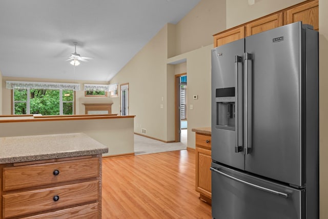 13403 96th Pl N, Maple Grove, MN 55369 - kitchen with high quality fridge, vaulted ceiling, a fireplace, light wood-style flooring, and ceiling fan