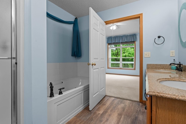 13403 96th Pl N, Maple Grove, MN 55369 - bathroom featuring double vanity, a garden tub, and wood finished floors