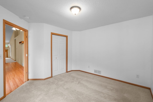 13403 96th Pl N, Maple Grove, MN 55369 - unfurnished bedroom featuring carpet flooring, a textured ceiling, baseboards, and a closet