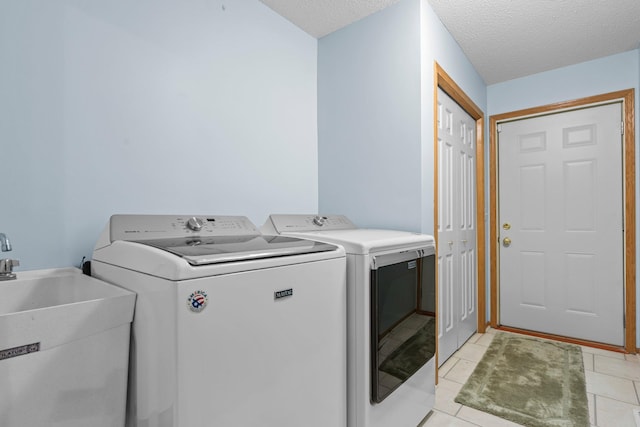 13403 96th Pl N, Maple Grove, MN 55369 - washroom featuring separate washer and dryer, light tile patterned floors, and a textured ceiling