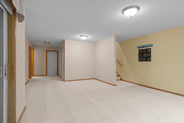 13403 96th Pl N, Maple Grove, MN 55369 - basement featuring light colored carpet, stairs, a textured ceiling, and baseboards