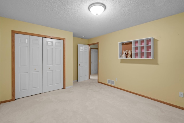 13403 96th Pl N, Maple Grove, MN 55369 - unfurnished bedroom featuring carpet flooring, a closet, baseboards, and a textured ceiling