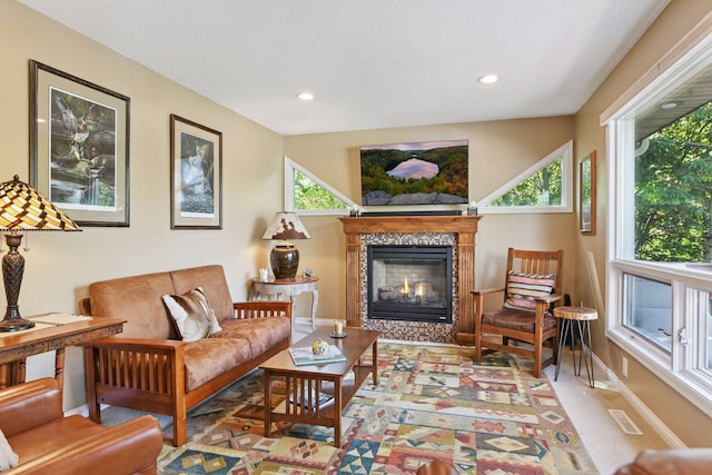 3806 Sunset Dr, Spring Park, MN 55384 - living room featuring a tiled fireplace, healthy amount of natural light, a textured ceiling, recessed lighting, and baseboards