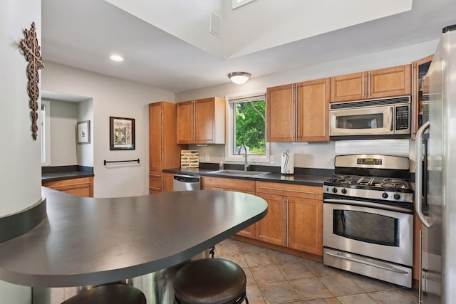 3806 Sunset Dr, Spring Park, MN 55384 - kitchen with appliances with stainless steel finishes, dark countertops, a sink, recessed lighting, and brown cabinets