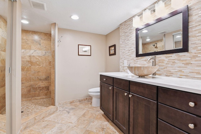 3806 Sunset Dr, Spring Park, MN 55384 - full bathroom featuring vanity, toilet, a tile shower, decorative backsplash, and baseboards