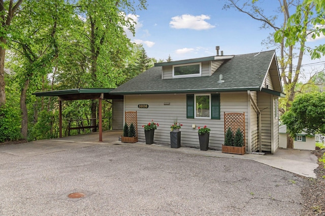3806 Sunset Dr, Spring Park, MN 55384 - view of front facade featuring driveway, roof with shingles, and an attached carport