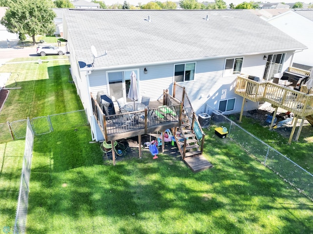 back of property with a wooden deck, central AC, and roof with shingles