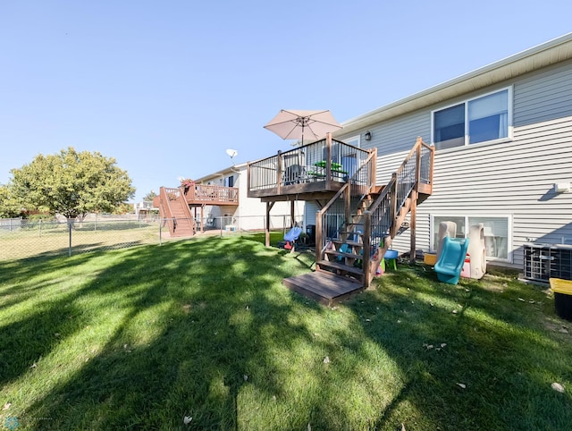 rear view of property featuring stairs and a wooden deck