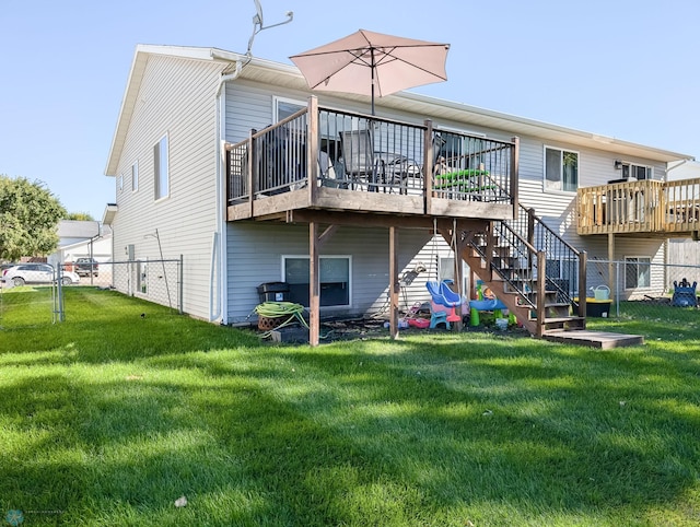rear view of property featuring a wooden deck and stairway