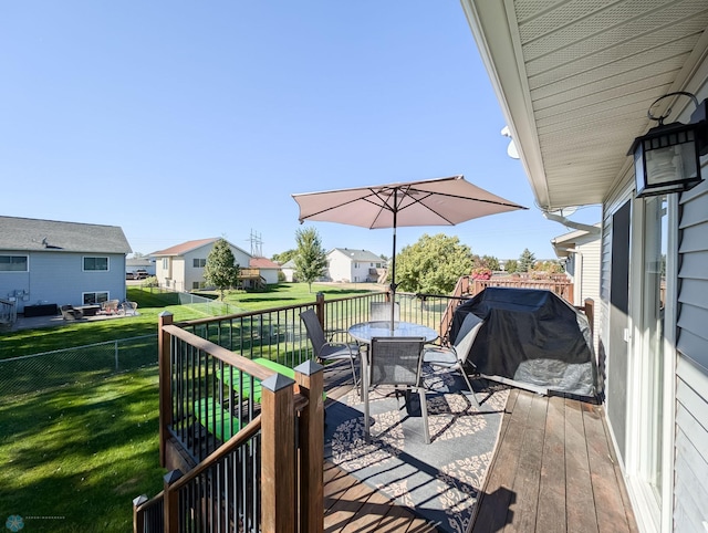 deck with outdoor dining area and a residential view