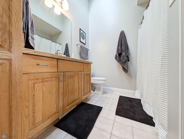 full bath featuring vanity, toilet, baseboards, and tile patterned floors
