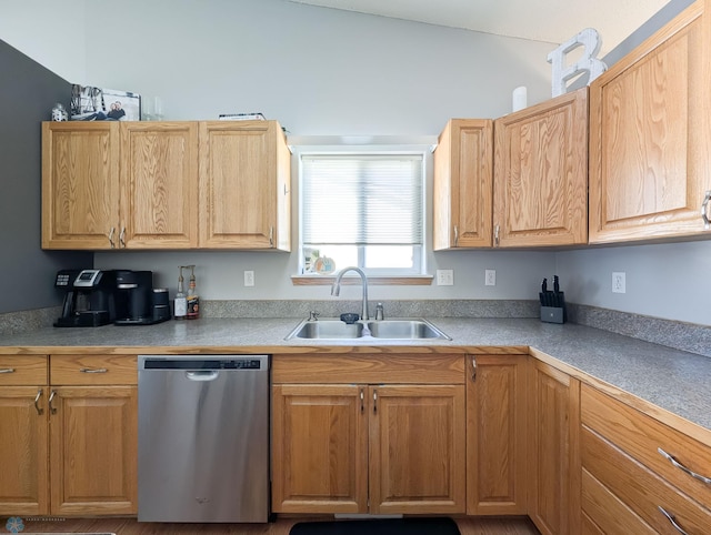 kitchen with stainless steel dishwasher, a sink, and light countertops