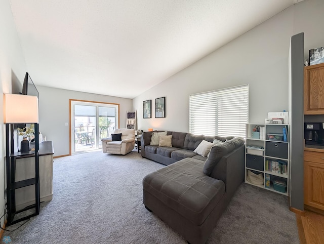 carpeted living room featuring vaulted ceiling