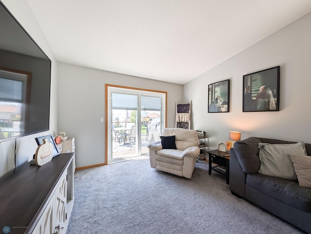 carpeted living area with baseboards