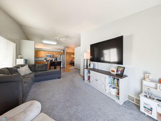 living room with light carpet, lofted ceiling, and a ceiling fan