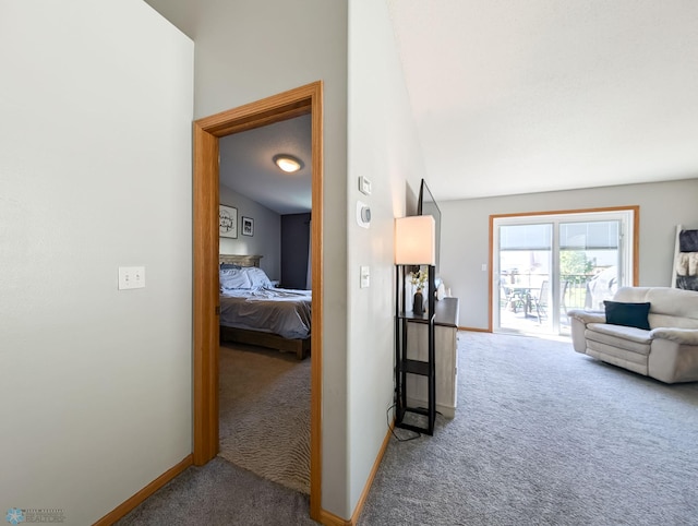 hall featuring carpet floors and baseboards