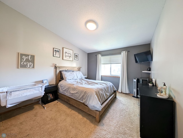 bedroom with light colored carpet and lofted ceiling
