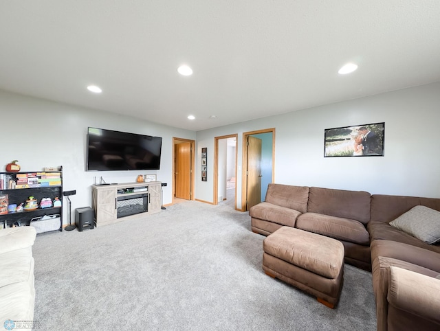 living area with light colored carpet, recessed lighting, baseboards, and a high end fireplace