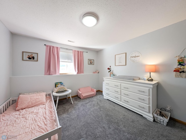 bedroom featuring carpet, a textured ceiling, and baseboards