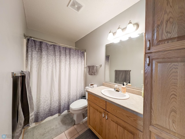 bathroom featuring tile patterned flooring, toilet, vanity, and a shower with curtain