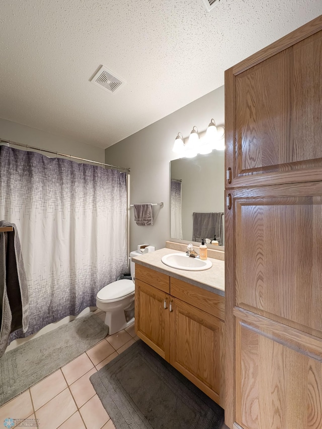 full bathroom featuring tile patterned flooring, vanity, toilet, a textured ceiling, and a shower with shower curtain