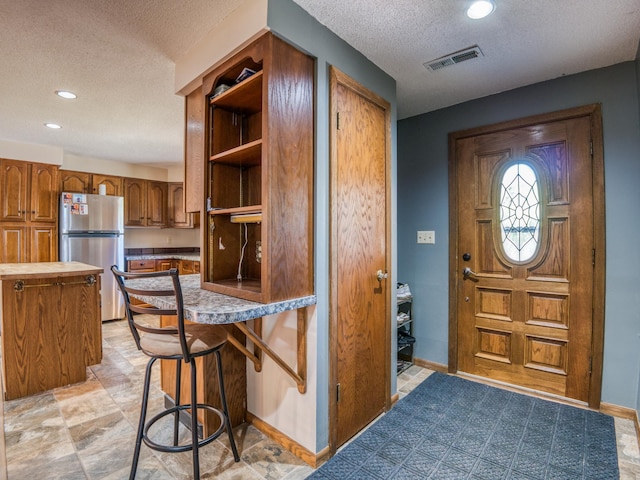 300 27th St NE, Bemidji, MN 56601 - foyer featuring a textured ceiling, recessed lighting, and baseboards