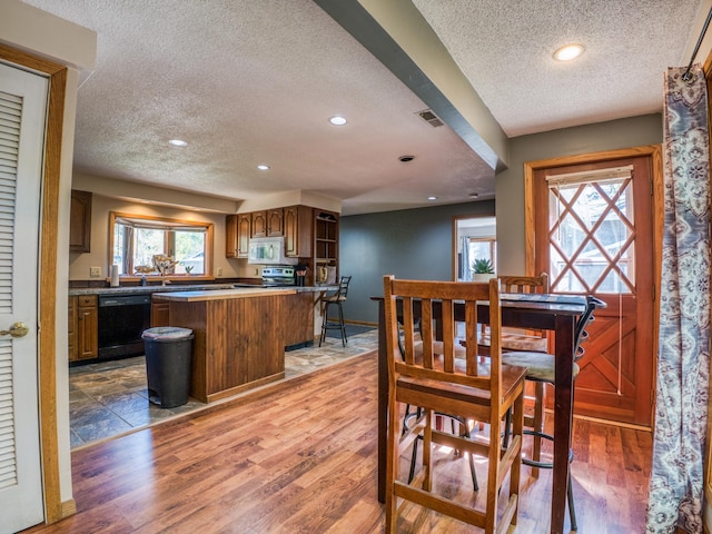 300 27th St NE, Bemidji, MN 56601 - dining room featuring a textured ceiling, recessed lighting, and wood finished floors