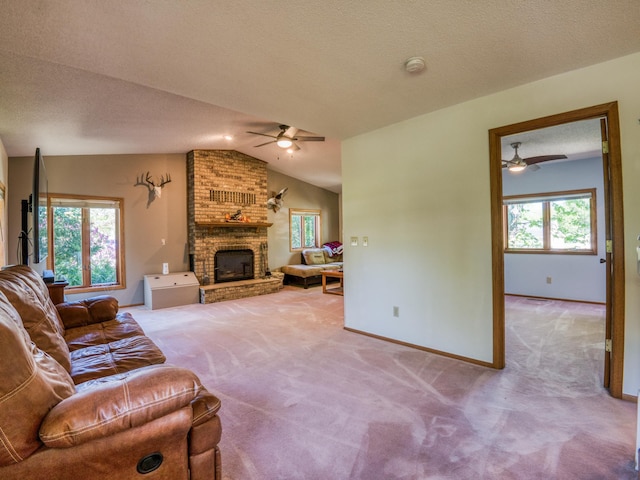 300 27th St NE, Bemidji, MN 56601 - carpeted living area featuring ceiling fan, vaulted ceiling, a brick fireplace, and baseboards