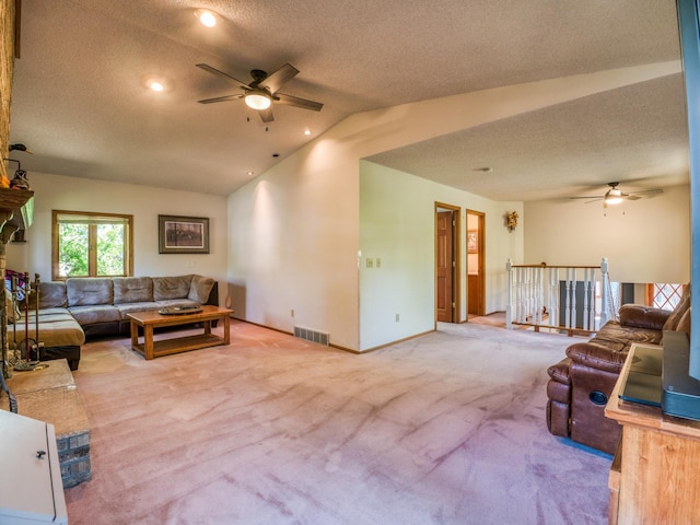 300 27th St NE, Bemidji, MN 56601 - carpeted living area with ceiling fan, lofted ceiling, baseboards, and a textured ceiling