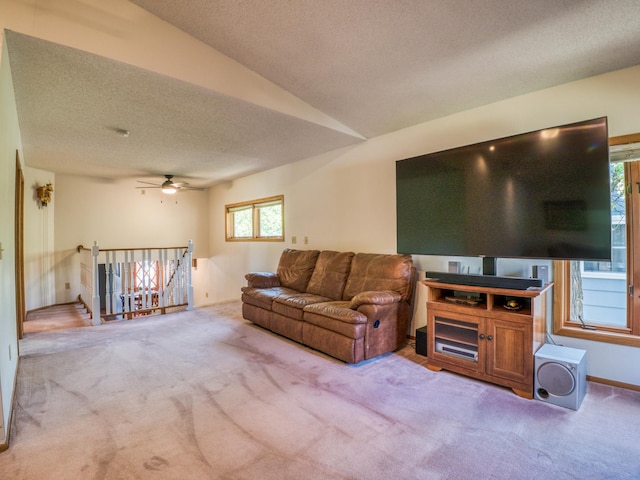 300 27th St NE, Bemidji, MN 56601 - living room featuring carpet flooring, a textured ceiling, ceiling fan, and vaulted ceiling