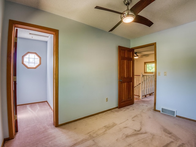 300 27th St NE, Bemidji, MN 56601 - unfurnished room with light carpet, ceiling fan, and baseboards